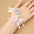 Romantic bridal wrist corsage with silk flowers, pearls and rhinestones in soft pastel tones - Light Blue