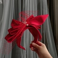 Detail of red satin bridal headband with mesh veil and pearl embellishments - Large Bow Mesh Style (WV42 B010402) / Red