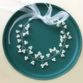 Handmade bridal hair vine with white pearls and organza ribbons on green tray - Pearl Hair Chain (White Ribbon)