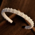 Elegant bridal headband featuring tiered white faux pearls on a premium white and black base - Style 2