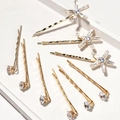 Forcine dorate con stelle in zircone e cristalli su piedistalli bianchi eleganti - Oro