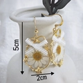 Daisy flower earrings in gold frame with white lace bow hanging on ceramic vase - Chamomile Bow Style
