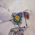 Macro view of handmade silver ring with real yellow and blue dried flowers inlay - Blue Floral Style