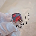 Detailed macro view of handmade dried flower resin ring surface measuring 1.8cm by 1.5cm - Red Flower Style