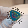 Macro detail of handmade resin ring with pink dried flowers and a pearl in blue finish - Style D