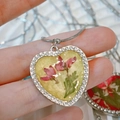 Macro detail of heart resin pendant with pink dried flowers and rhinestone trim - Pink Dried Flower Yellow Base (Style C)