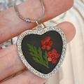 Macro shot of a heart-shaped silver necklace featuring red dried flowers and crystal details - Red Dried Flower with Black Base (Style I)