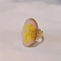 Close-up of handmade gold ring with pink resin, yellow dried flowers and hammered texture - Pink Base Yellow Dried Flower Gold Band Style (C款)