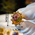 Macro shot of a 2.0x1.7cm oval resin ring with real purple dried flowers and gold frame - Purple Dried Flower Oval Style (Style A)