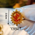 Detailed view of handmade gold ring with red dried flower inside an oval bezel - Red Floral Branch Beaded Edge Style (Style C)