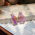 Detailed shot of handmade cat-shaped earrings featuring real purple and yellow dried flowers - Purple Series Earrings / Purple Series Earrings