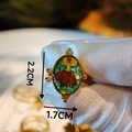 Detailed macro view of handmade gold floral ring with real red dried flower and resin oval face - Red Flower Green Base Beaded Trim (Style E)