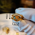 Detailed macro view of gold bead ring with orange dried flower and resin oval surface - Orange & Blue Dried Flower Round Bead Style (Type F)
