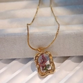 Macro shot of gold necklace featuring purple dried flowers in a textured resin pendant - Purple Lavender Gold Frame (Style F)
