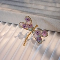 Macro view of gold dragonfly ring featuring purple dried flowers and sparkling glitter - Pink-Purple Gradient Dried Flowers Gold Base (Style D)
