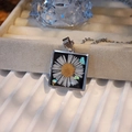 Detail of square resin pendant with white dried daisy flower and colorful shell fragments - Square Style B