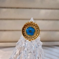 Detail view of a vintage sunray ring with a blue flower center on a crystal stand - Deep Blue Flower Radiant Style (Style C)