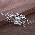 Detailed close-up of bridal hair comb with pearls and marquise crystals on silver wire - Silver