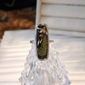 Macro shot of handmade resin ring with real white flowers and green leaves on silver band - Foxtail Grass