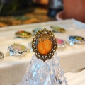 Macro shot of vintage bronze oval ring featuring real orange dried flowers and lace edges - G Style Antique Bronze
