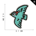 Blue bird embroidery patch with red festive hat and dimensions 4.2cm x 3.1cm - Bird in Festive Hat Motif (H)