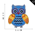 Embroidered owl patch with blue body and yellow wings, measuring 6.5 cm by 5.6 cm - Blue Base Wave Pattern Owl (12)