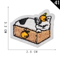Self-adhesive embroidered patch featuring a sleeping cat in a box with orange accents - Black White Cat in Box (41)