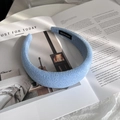 Detailed close-up of light blue knitted wool headband with a handmade textile label - Thick Knitted Headband (HANDMADE Label) / Sky Blue