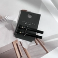Detail of two black bow hair clips with gold buckles on a display card for styling - Black Bow (1 Pair)