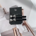 Elegant set of black bow hair clips with heart diamonds on a minimalist display stand - Rhinestone Bow (1 Pair)