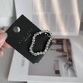 Close-up of cloud-shaped hair clip with sparkling Czech rhinestones on black base - White