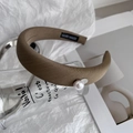 Close-up of brown wide fabric headband with pearl detail and handmade interior label - Khaki