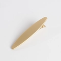 Detail shot of the matte gold minimalist long metal hair clip on a clean white surface - Simple Solid Style / Gold