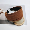 Detailed macro view of the caramel brown knitted texture on this wide minimalist headband - Caramel color