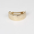 Macro detail of golden metal barrette with vertical brushed texture and curved design - Brushed / Gold