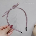 Detail of light purple satin headband with handcrafted side bow and soft end caps - Light Purple