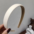 Detail view of cream white thick headband featuring textured lychee grain leather finish - Milk White