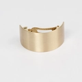 Detailed macro view of matte gold brushed metal curved hair clip with spring fastener - Wide Version / Gold