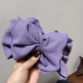 Detailed macro of a purple ribbed fabric headband featuring a large bow design - Light Purple