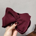 Close-up of wine red knitted ribbed bow headband with high-elastic fabric and soft texture - Burgundy