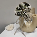 Detail of French style green marble pattern hair scrunchie with beige bow on ceramic vase - Green