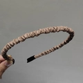 Close-up of mocha brown pleated PU leather thin headband with soft black fabric end tips - Khaki