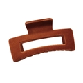 Detailed view of large rusty red flocked hair claw clip with rectangular cutout design - Dark Orange