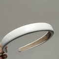 Detail of elegant white faux sheepskin padded headband with non-slip velvet inner lining - White