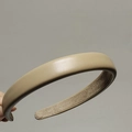 Detail view of beige sponge headband featuring lychee grain faux leather and non-slip lining - Khaki