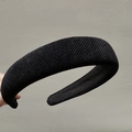 Detail of a wide black padded headband featuring vintage vertical ribbed knit texture - Black