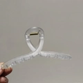 Detail of a large matte transparent hair claw clip with cross-loop design and metal spring - Smoke Gray
