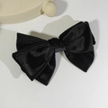 Detailed top view of a classic black velvet double-layer bow hair clip on a white surface - Black