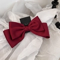 Detail of elegant wine red satin bow hair clip with high-quality silk texture - Red