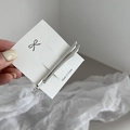 Close-up of two polished silver minimalist hair clips on a white presentation card - Silver Barrette